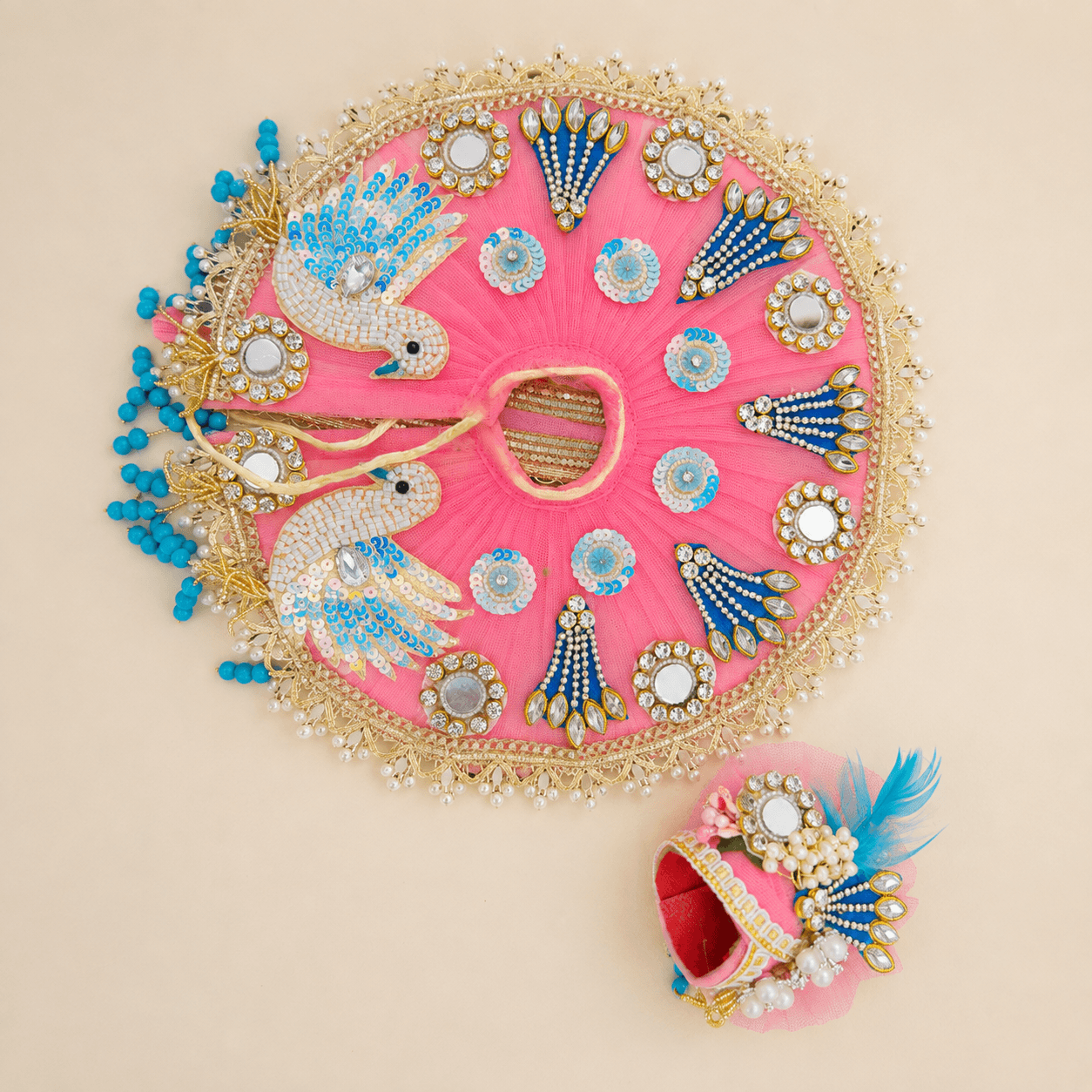 Rose pink net poshak with sequin parrots, mirror kundan and a matching pagh